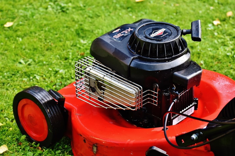 equipment, land vehicle, mode of transportation, cut grass, metal, lawn mower, land, technology, day, gardening, close-up, lawnmower, focus on foreground