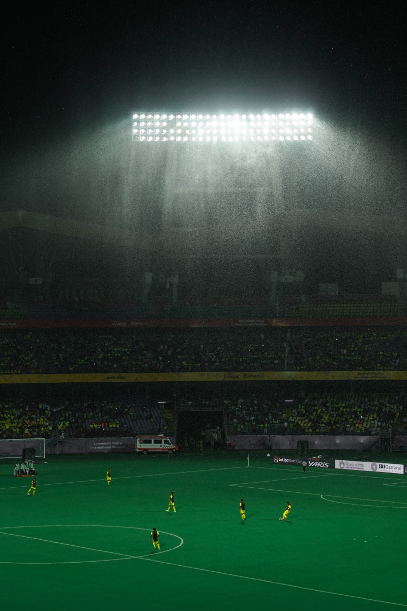 spectator, football, green color, illuminated, group of people, sky, 5K, grass, floodlit, soccer field, rain, sport, competition, real people, men, playing
