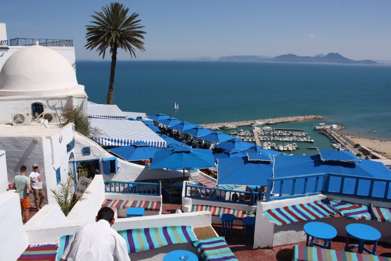 cafe, sky, water, vacations, mediterranean, high angle view, city, lifestyles, men, mountain, tunis, port, architecture, sunlight, building exterior, rear view