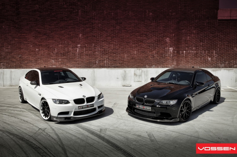 stationary, motor vehicle, black cars, no people, black, vehicle, wall - building feature, mode of transportation, building exterior, white cars, brick wall