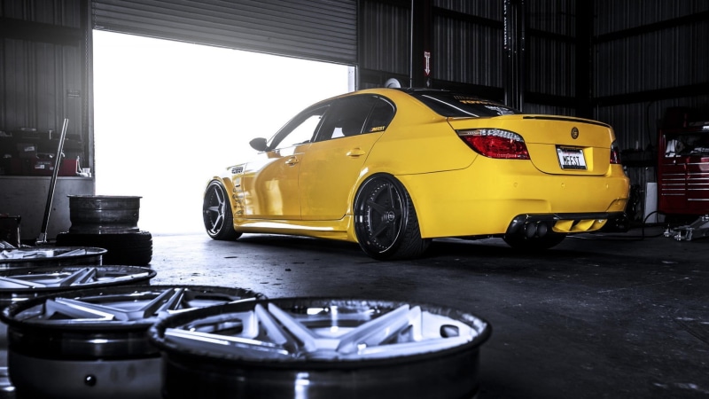 retro styled, architecture, day, land vehicle, wheel, built structure, indoors, 1080P, yellow, tire, mode of transportation, garage, BMW M5, motor vehicle