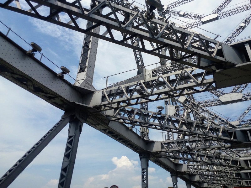 india, girder, bridge - man made structure, low angle view, day, built structure, transportation, sky, nature, kolkata, outdoors, metal, grid, cloud - sky