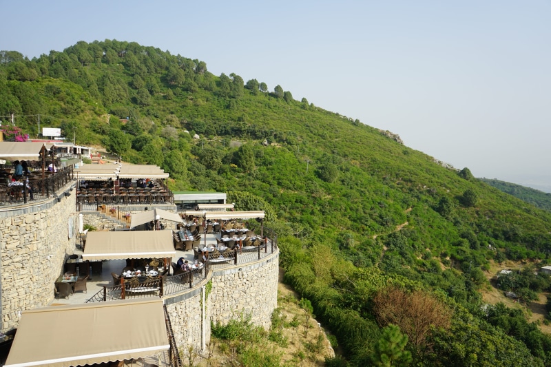 building, incidental people, travel, fall, outdoors, roadtrip, group of people, roof, building exterior, green color, green, scenic, day, margala hills