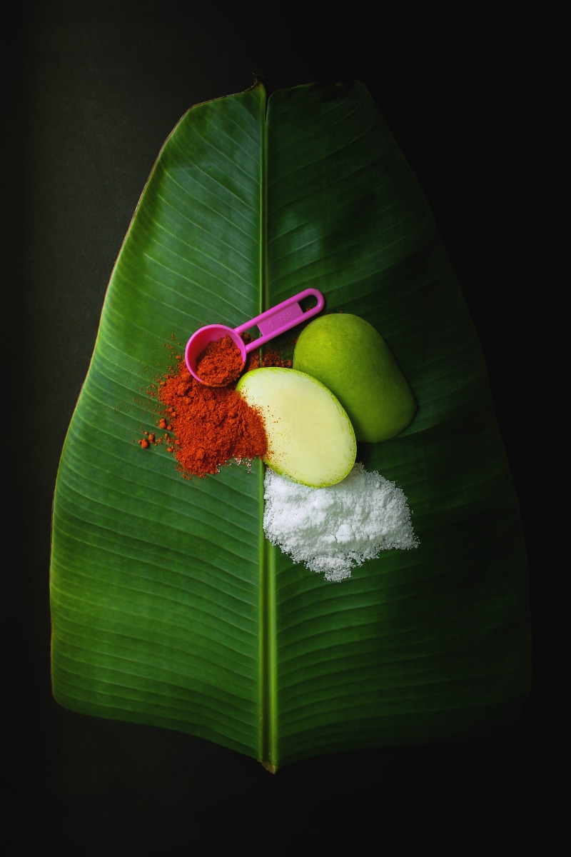 plant, banana leaf, chill, black background, leaf, green mango, wellbeing, freshness, powder, food, flower, salt, 8K, studio shot, indoors, no people
