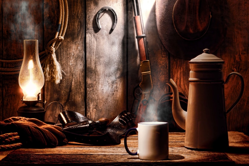 lantern, indoors, food and drink, lamp, table, kerosene, brown, domestic room, horseshoe, rifle, single Object, still Life, colt, ammunition, Western, container