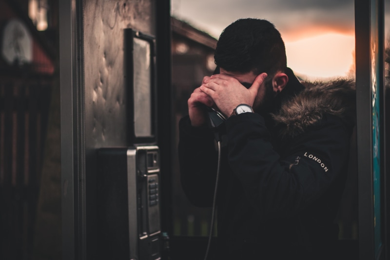 embracing, two people, togetherness, couple - relationship, indoors, males, lifestyles, young men, phone, standing, man, hand, adult, telephone, male, phonebooth
