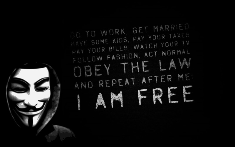 monochrome, 720P, headshot, mask - disguise, indoors, representation, fawkes, anonims, black background, text, artwork, mask, western script, communication