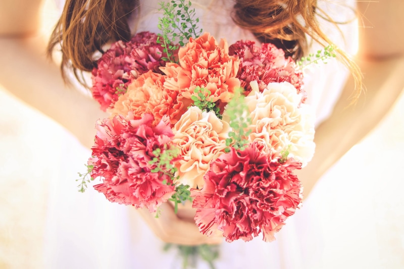 holding, plant, bouquet, love, outdoors, flowering plant, vulnerability, red, one Person, flower, celebration, dress, one woman only, beauty, orange, hairstyle