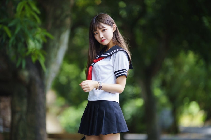 casual clothing, innocence, focus on foreground, schoolgirl, sailor uniform, real people, one person, leisure activity, lifestyles, childhood, necklace