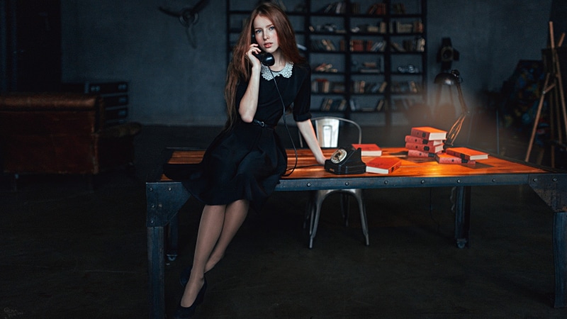 casual clothing, long, sitting, sleeved, technology, telephone, holding, black, wireless technology, one person, hairstyle, front view, freckles, white