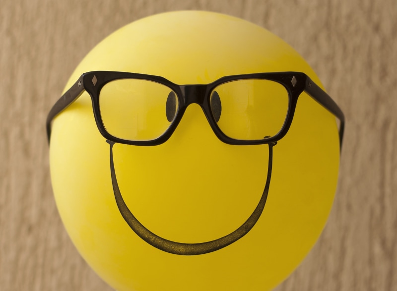 security, focus on foreground, close-up, eyeglasses, wood - material, yellow, sunglasses, 2K, no people, still life, nerdy, table, emoji, quirky, creativity