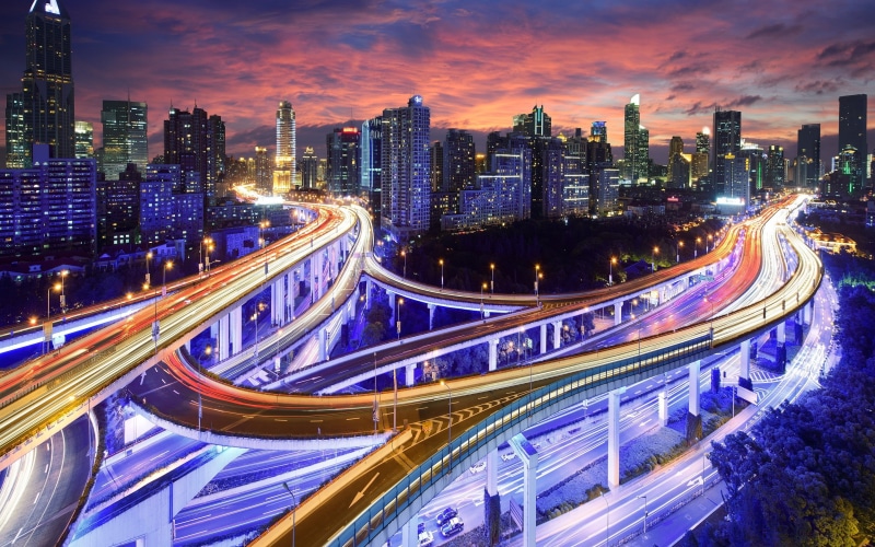road, overpass, high, night, motion, high angle view, purple, no people, traffic, light trails, office building exterior, multiple lane highway, city street