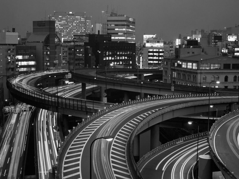 architecture, office building exterior, building exterior, overpass, track, cityscape, photo, multiple lane highway, transportation, long exposure, monochrome