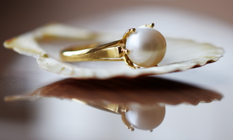 pearl jewelry, indoors, white, freshness, gold, two objects, no people, colored, gold colored, selective focus, shiny, elegance, food, ring, food and drink