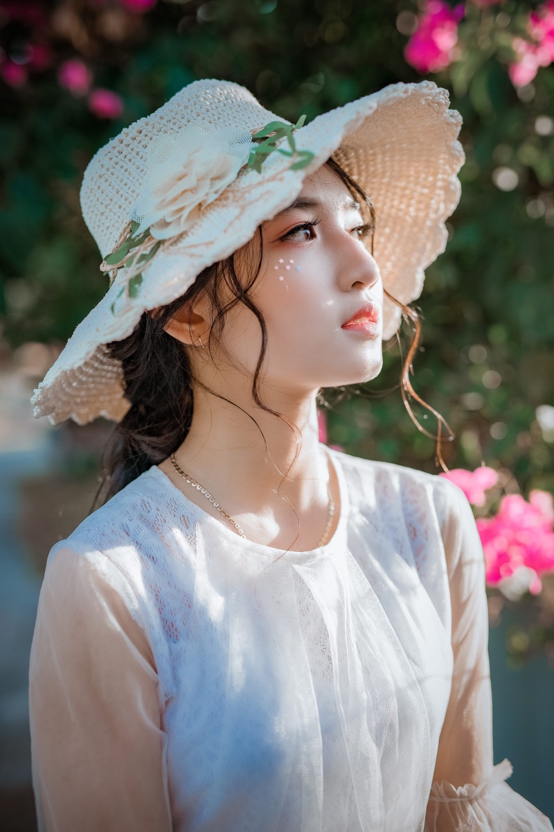 hairstyle, plant, women, focus on foreground, clothing, adult, young adult, one person, headwear, wearing, wear, front view, flowering plant, young women