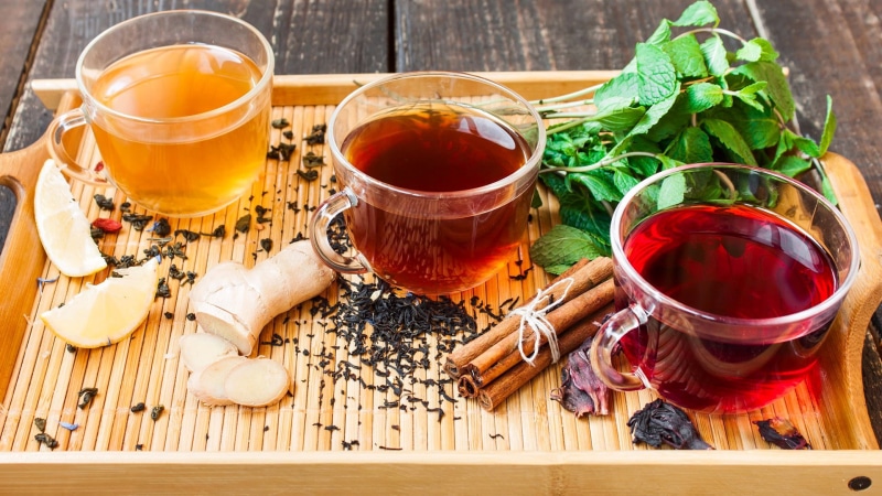 food, herb tea, mug, indoors, crockery, wood - material, plant, cinnamon, household equipment, high angle view, hot drink, mint tea, herbal tea, glass