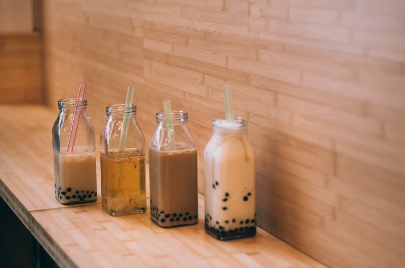 glass - material, food, bottle, healthcare and medicine, hipster, indoors, container, tea, beverage, boba, medium group of objects, no people, jar, in a row
