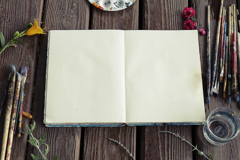 textured, art materials, high angle view, publication, art supplies, art, table, flowers, indoors, creativity, paint brushes, old, rustic, directly above