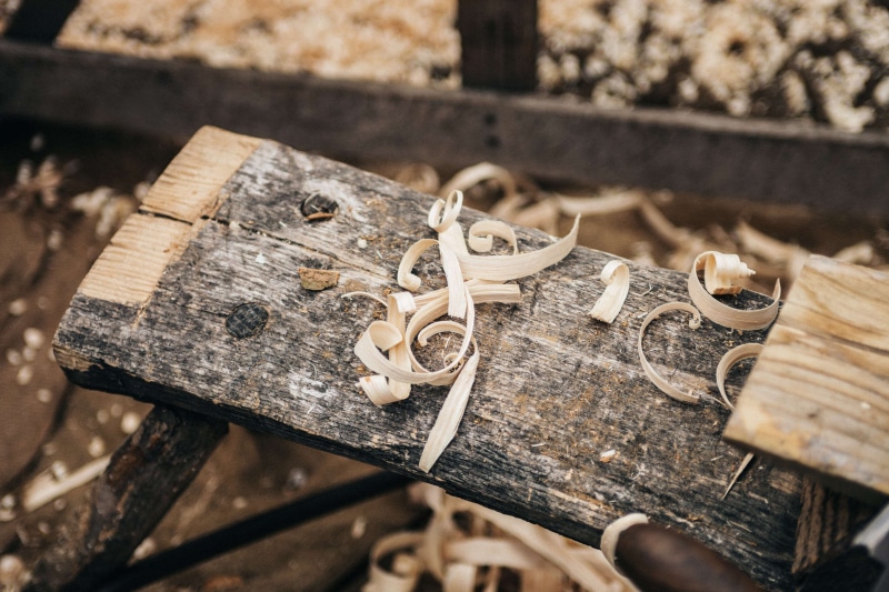 4K, outdoors, large group of objects, wood - material, arts and crafts, wood shavings, focus on foreground, old, wooden, day, gold colored, emotion, still life