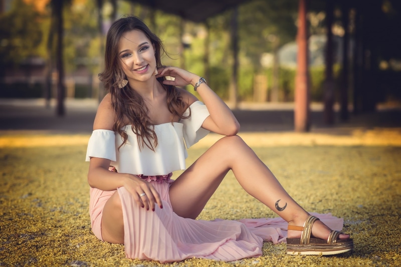 long hair, legs, pink skirt, women, strapless dress, sitting, smiling, red nails, brown eyes, model, Lucia, white tops, blouse, 1080P, wavy hair, brunette