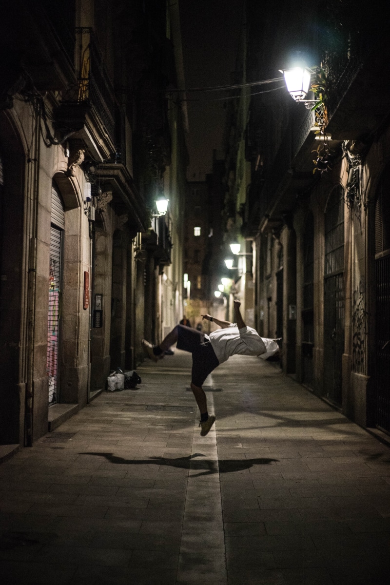 flip, city, shadow, urban, trick, nighttime, road, built structure, backflip, direction, lifestyles, adventure, illuminated, man, building exterior, real people