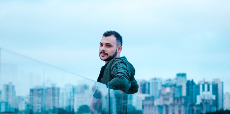 beard, outdoors, buildings, jacket, office building exterior, looking at camera, architecture, building, 4K, man, wear, sky, glass, fashion, cityscape
