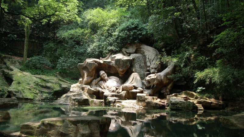 lying, outdoors, man, forest, art and craft, human representation, day, no people, solid, growth, 2K, flowing water, representation, tiger, lake, rock - object