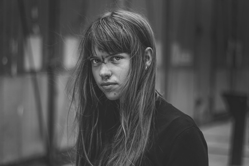 bangs, wounds, 1080P, windy, leisure activity, hair in face, lifestyles, women, focus on foreground, monochrome, Stitches, one person, beautiful woman