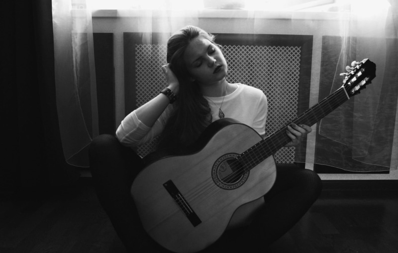 shirt, stringed instrument, plucking an instrument, crew, hairstyle, young women, curtain, playing, instrument, lifestyles, electric guitar, musician, guitar