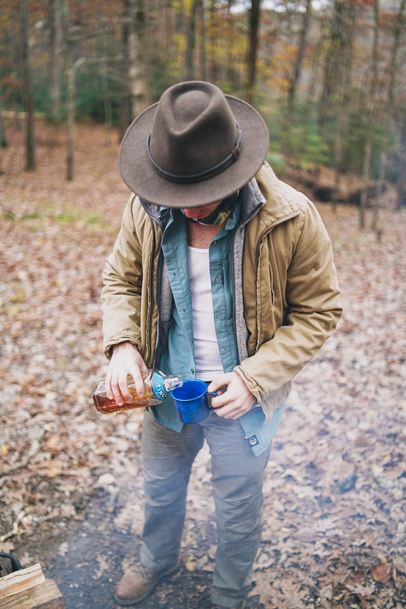 nature, gravel, one person, wearing, innocence, hat, shoe, lifestyles, outdoors, day, jacket, ground, brown, blue, tree, liquid, pouring, leisure activity