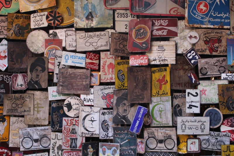 backgrounds, human representation, text, graffiti, abundance, communication, collage, message, bicycle, indoors, variation, person, symbol, wall - building feature