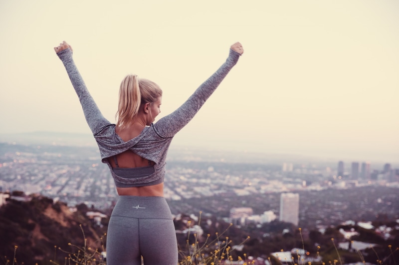 1080P, rear view, yoga pants, human arm, hairstyle, adult, young women, focus on foreground, arms raised, one person, beautiful woman, hair, women, cityscape