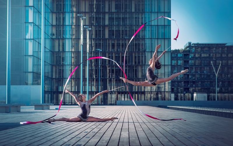 building exterior, office building exterior, flexible, lifestyles, gymnast, vitality, brunette, jumping, architecture, arms raised, young adult, leotard
