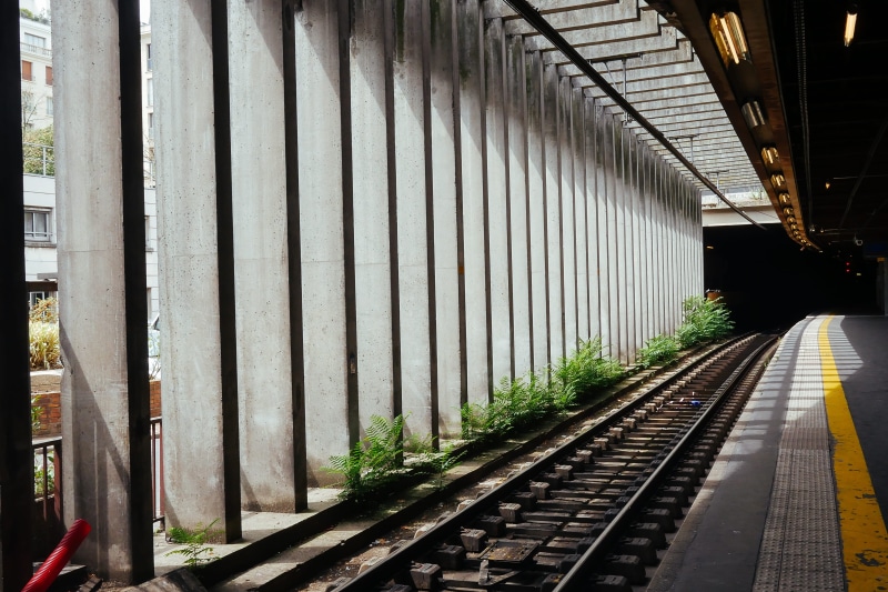 day, in a row, built structure, sun, direction, landscape, stone, transportation, railway, rail transportation, summer, concrete, metal, long, railroad station platform