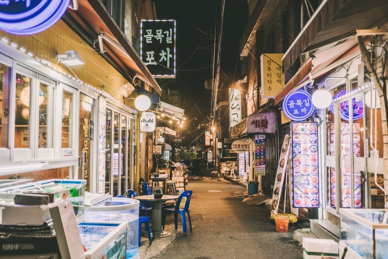 store, street, sidewalk, town, pavement, market, plastic, metropolis, city, architecture, road, communication, blue, real people, outside, chairs, building