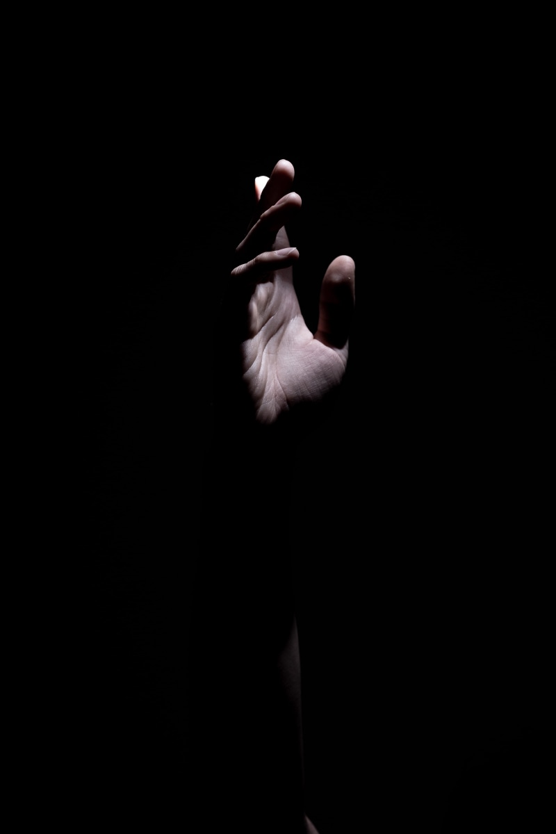 close-up, person, right, body, copy space, one person, black, dark, real people, holding, unrecognizable person, minimal, hand, contrast, body part, finger