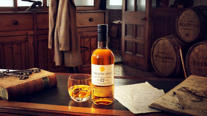 no people, newspaper, container, communication, whisky, paper, alcoholic beverage, food, indoors, cylinder, text, barrel, irish whiskey, still life, drink