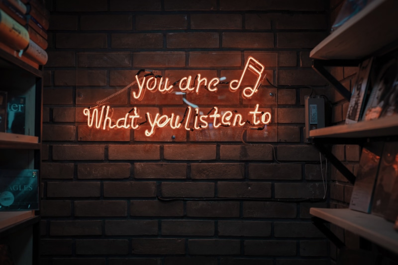 red, built structure, lighted, building exterior, communication, information sign, illuminated, store, text, neon, signage, orange, sign, note, music, shelves