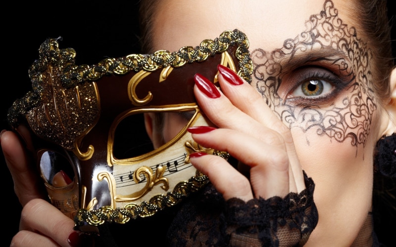 luxury, adult, carnival - celebration event, fashion, mask, makeup, young adult, brunette, disguise, one person, creativity, holding, women, covering face