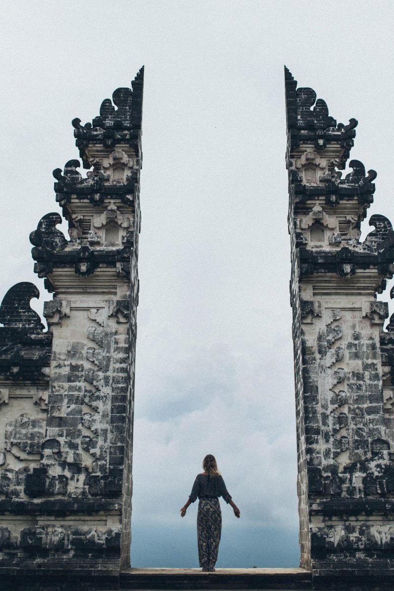 5K, lifestyles, woman, built structure, real people, building exterior, sky, split, ancient, nature, human arm, person, the past, sight, outdoors, standing