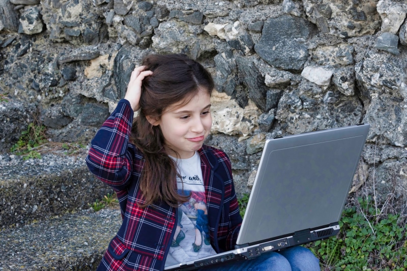 childhood, females, laptop, wireless technology, elegance, outdoors, doubts, learn, use, work, technology, solid, one person, hairstyle, little girl, notebook