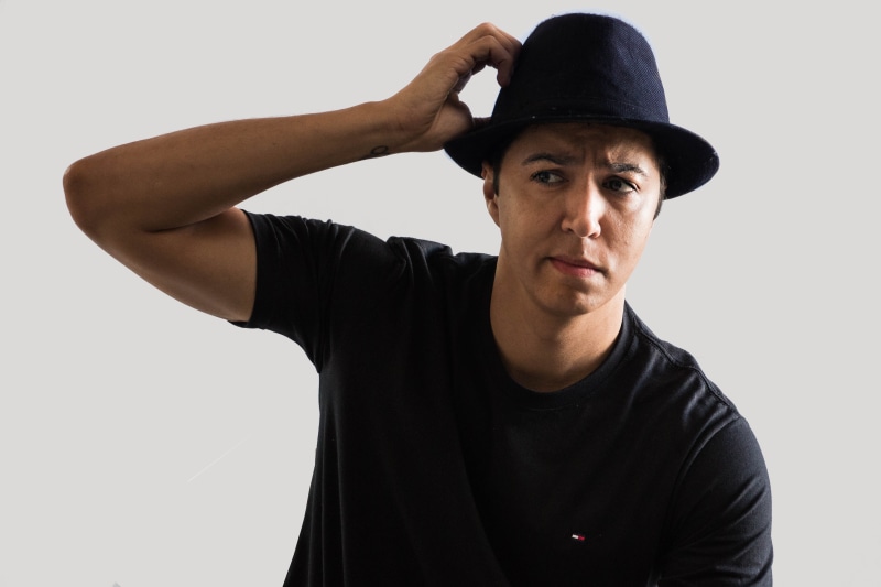 headshot, concern, white background, hat, confidence, looking, studio shot, portrait, doubt, front view, human arm, one person, young men, clothing, contemplation