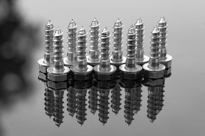 silver colored, screws, connection, blur, metallic, construction material, no people, side by side, gray, selective, indoors, iron, shiny, reflection, large group of objects