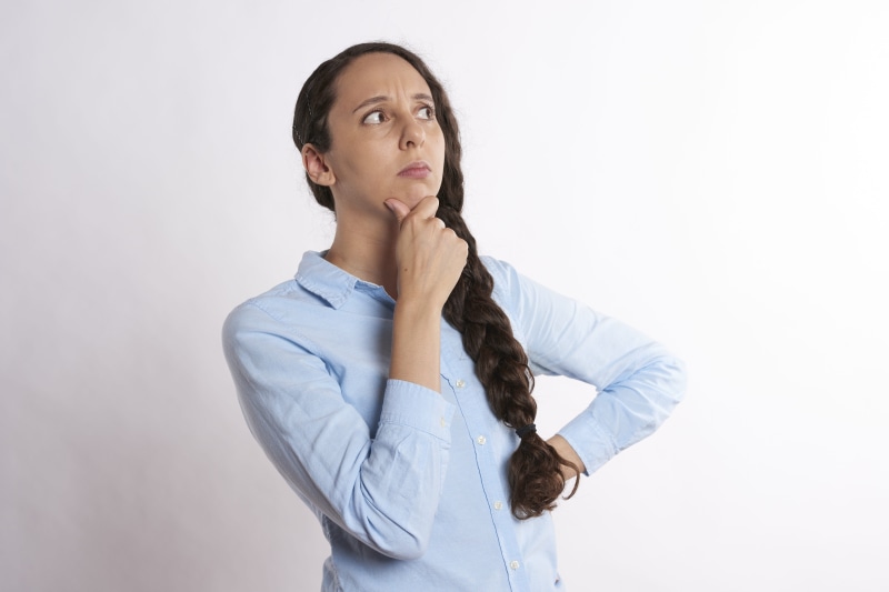 deliberating, introspective, looking, pain, long hair, work, person, long, serious, adult, woman, reflective, thoughtful, studio shot, contemplation, white background