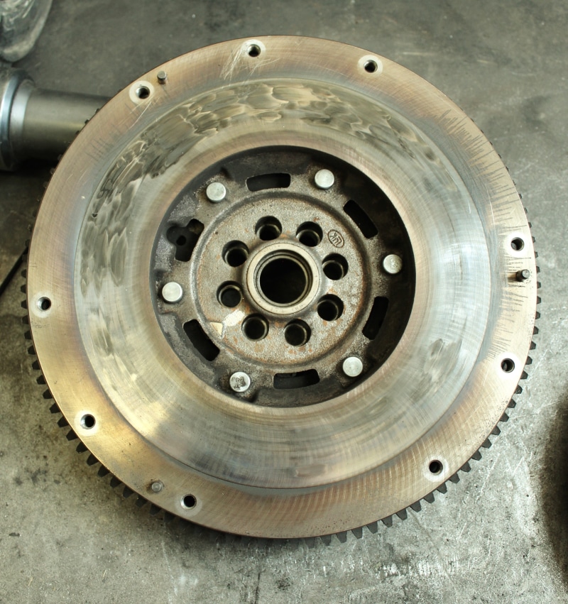 close-up, industry, silver colored, steel, technology, sprocket, wheel, day, metallic, workshop, mode of transportation, equipment, brake, high angle view