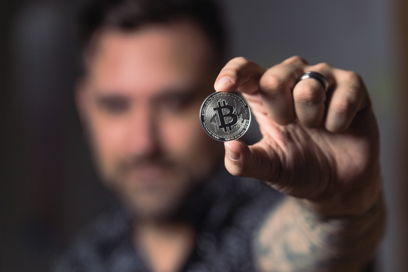 focus, human hand, adult, model, pocket watch, human body part, focus on foreground, bitcoin, hand, young adult, cryptocurrency, one person, money, indoors