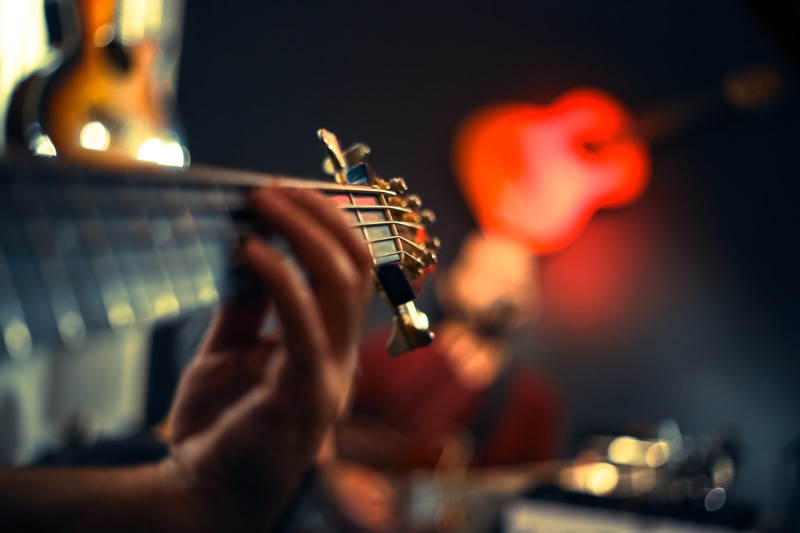 focus, close-up, blurred background, flame, skill, person, artist, human body part, one person, music, human hand, musical instrument, guitarist, holding