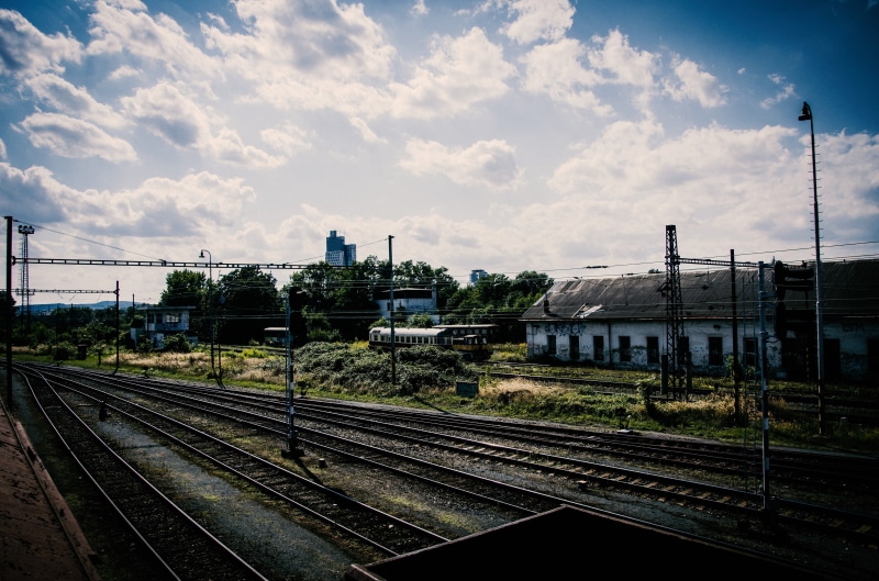 nature, railway, mode of transportation, rail yard, public transportation, cloud - sky, train - vehicle, building, railroad station, architecture, sky