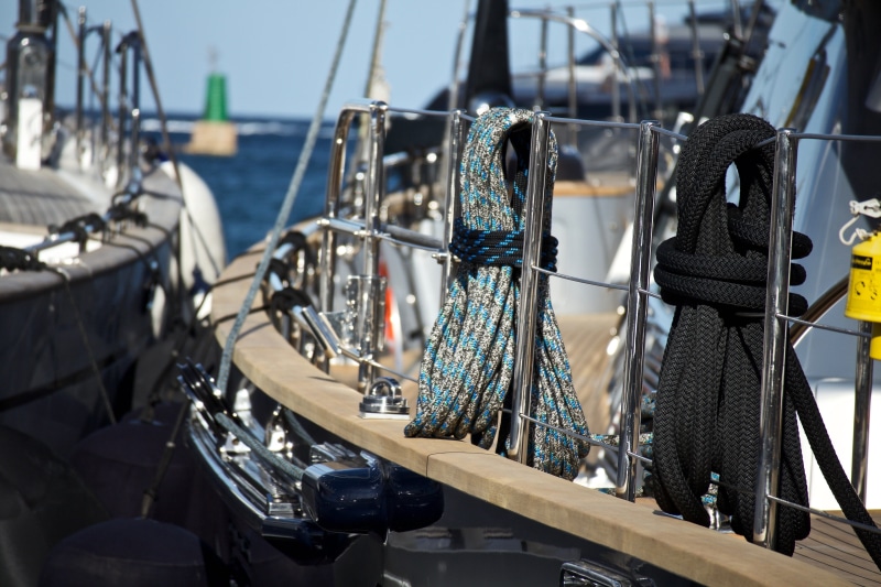 in a row, sunlight, consumerism, moored, hanging, no people, holidays, choice, sailboat, mode of transportation, large group of objects, luxury, wind, day