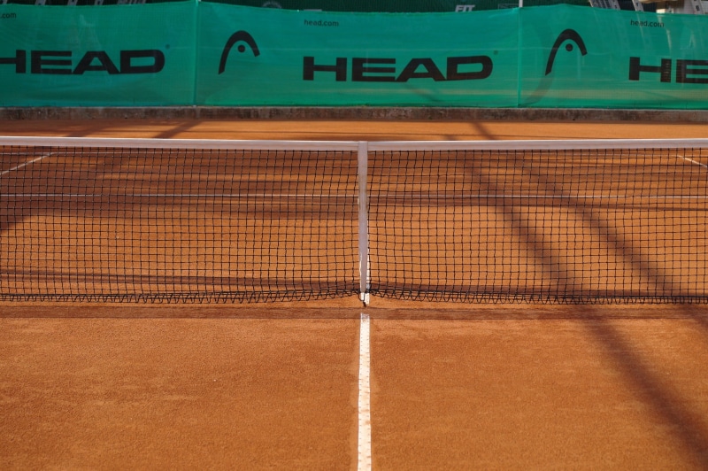 net - sports equipment, sports Venue, brown, net, tennis, guidance, text, outdoor, architecture, communication, day, head tennis, head, clay court, stadium